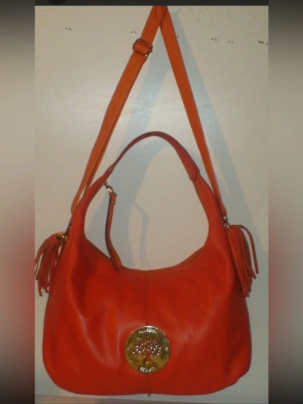Mulberry Orange Leather Hobo Bag with Tassels and Gold Emblem